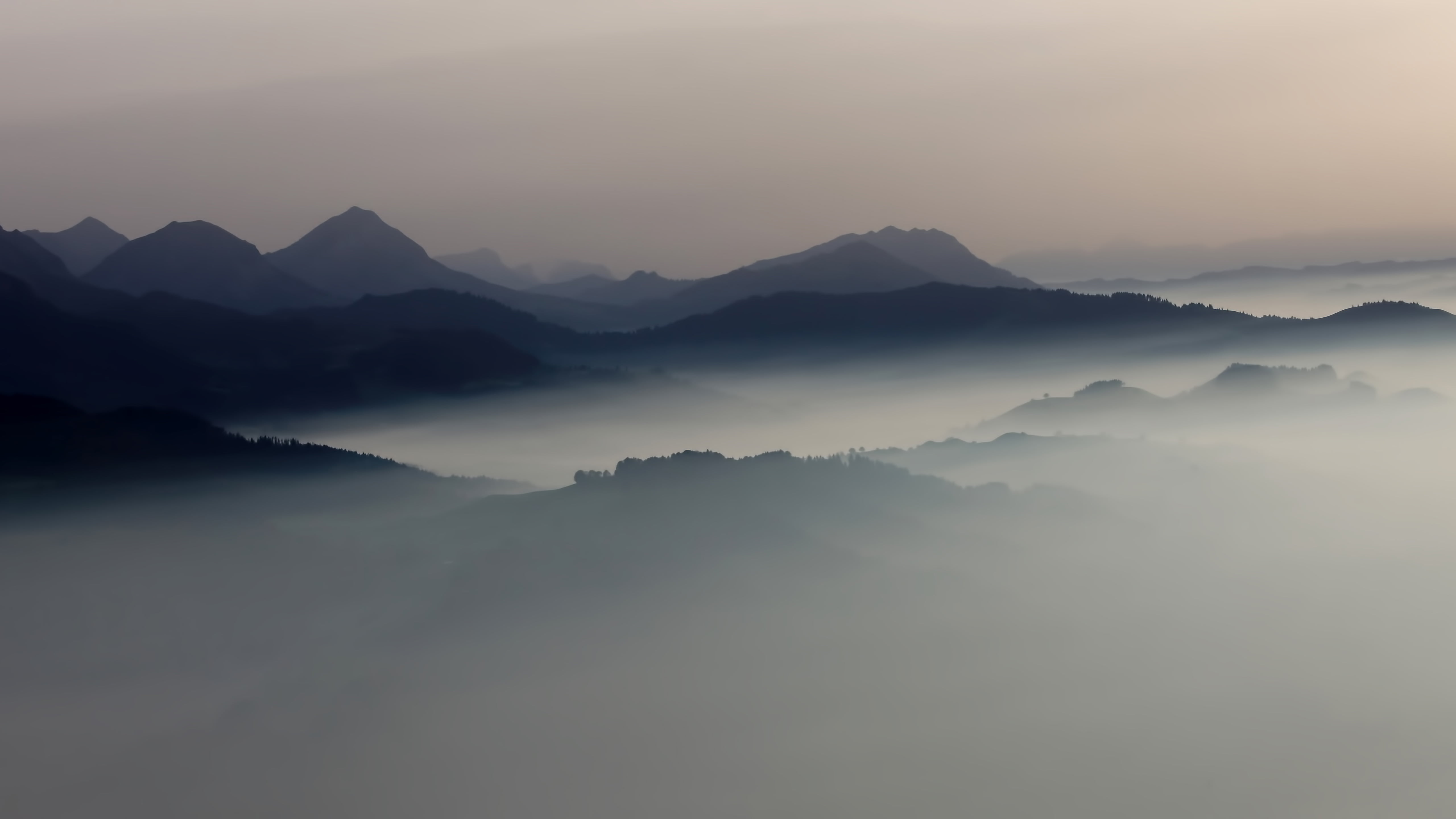 Layers of mountain ridges emerging through mist